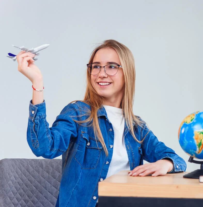 Student holding a model airplane
